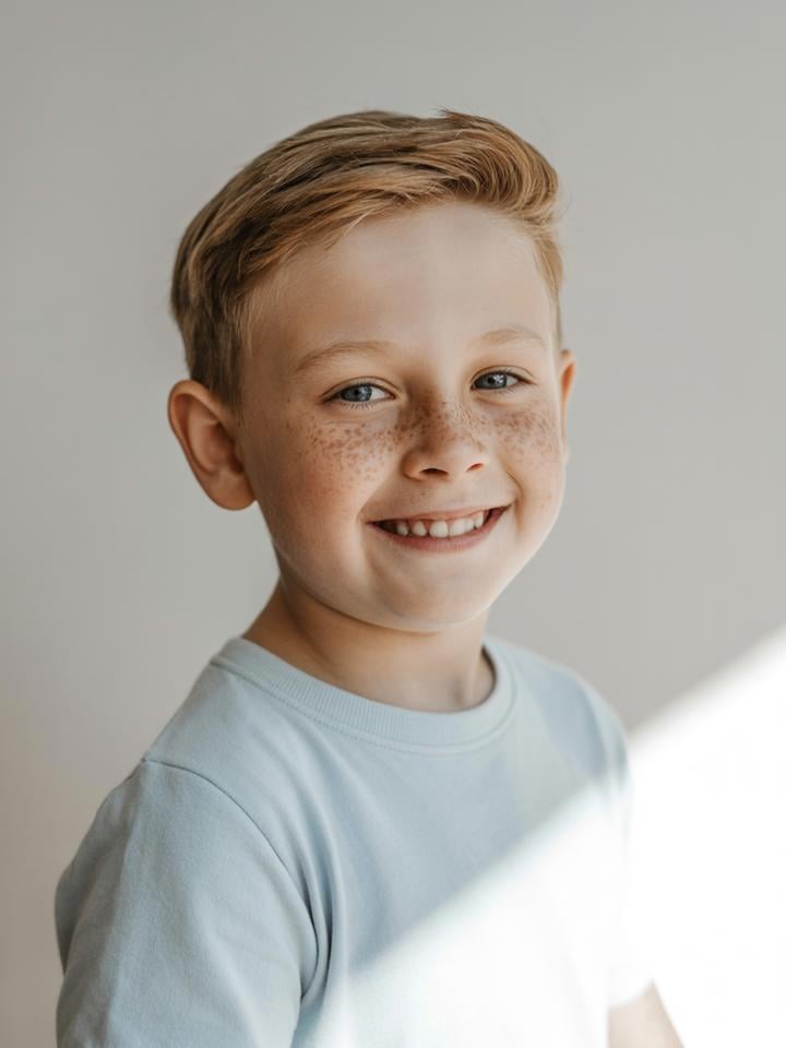 Finn — AI child model: Red-blonde hair, freckles, blue eyes